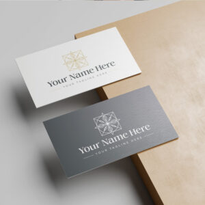 Two business cards, one white and one dark gray, featuring an elegant gold geometric star logo and placeholder text.