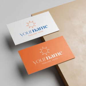 Two business cards, one white and one orange, displaying a bright sun logo and placeholder text for a name and tagline.